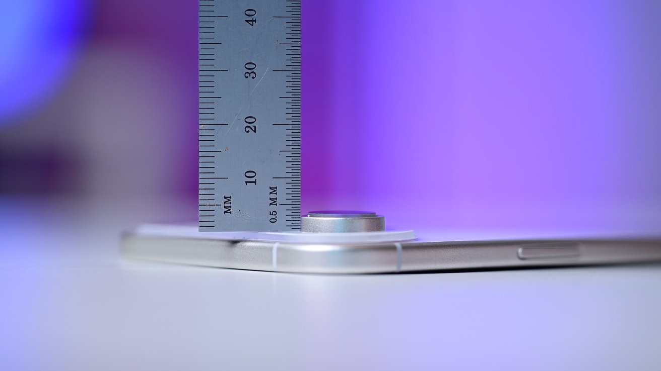 A close-up of a ruler measuring the thickness of a smartphone, with a purple gradient background.