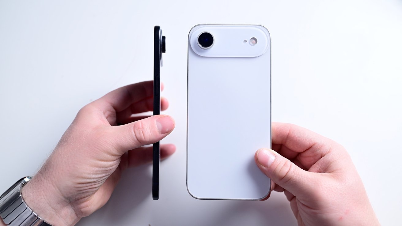 Two hands holding smartphones; left hand holds phone sideways, right hand holds white phone upright, showing camera.
