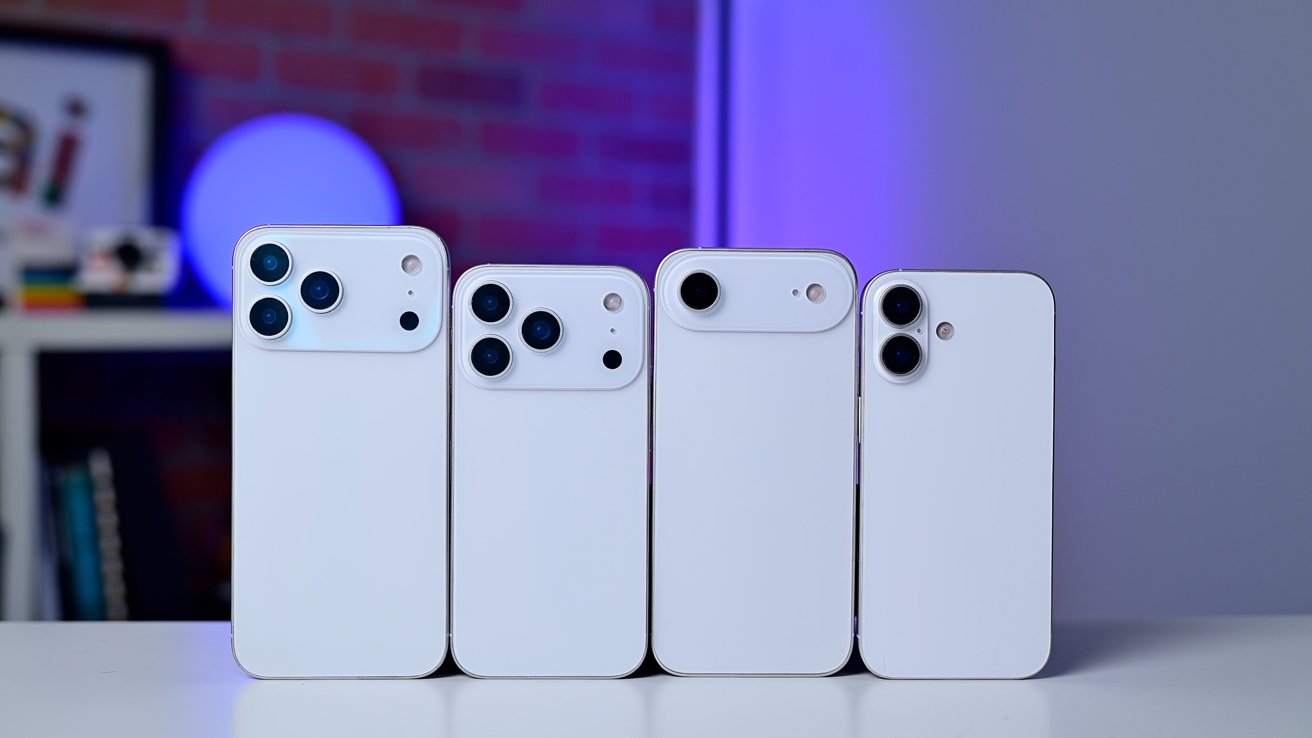 Four white smartphones with varying camera designs on a table, against a background with blue and red lighting.