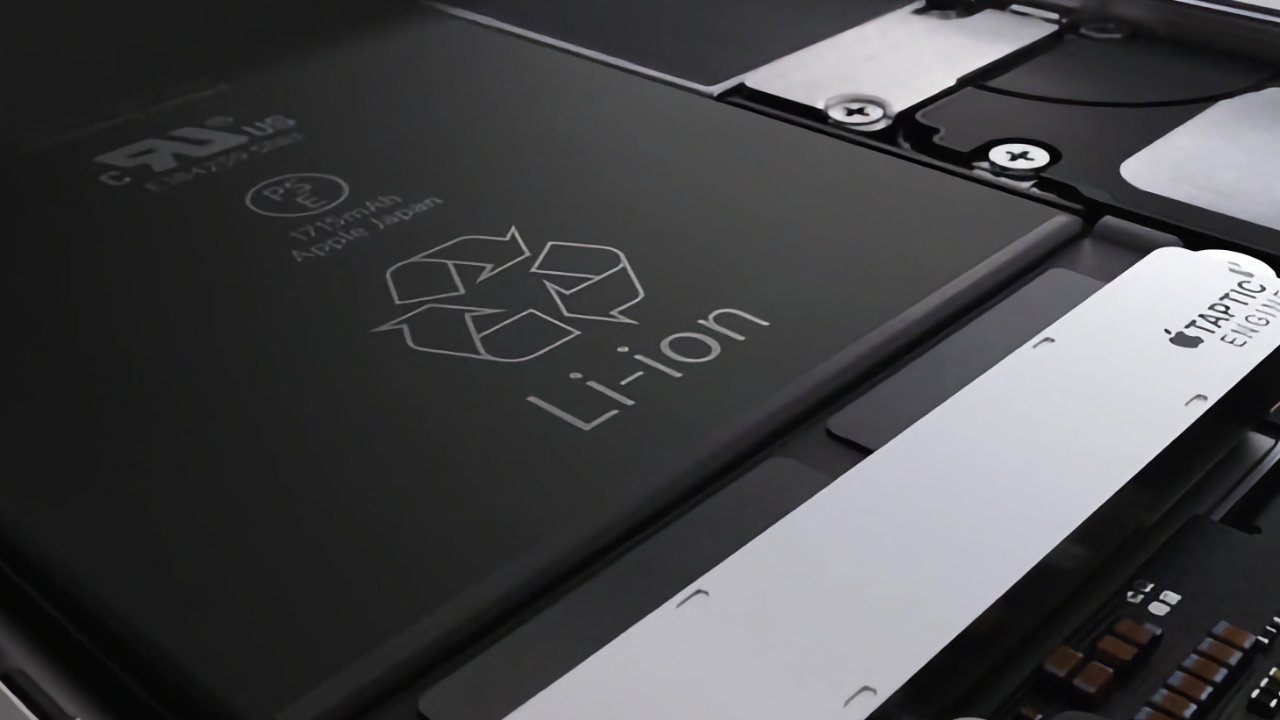 Close-up of a lithium-ion battery and Taptic Engine inside an electronic device, showing a recycling symbol and text.