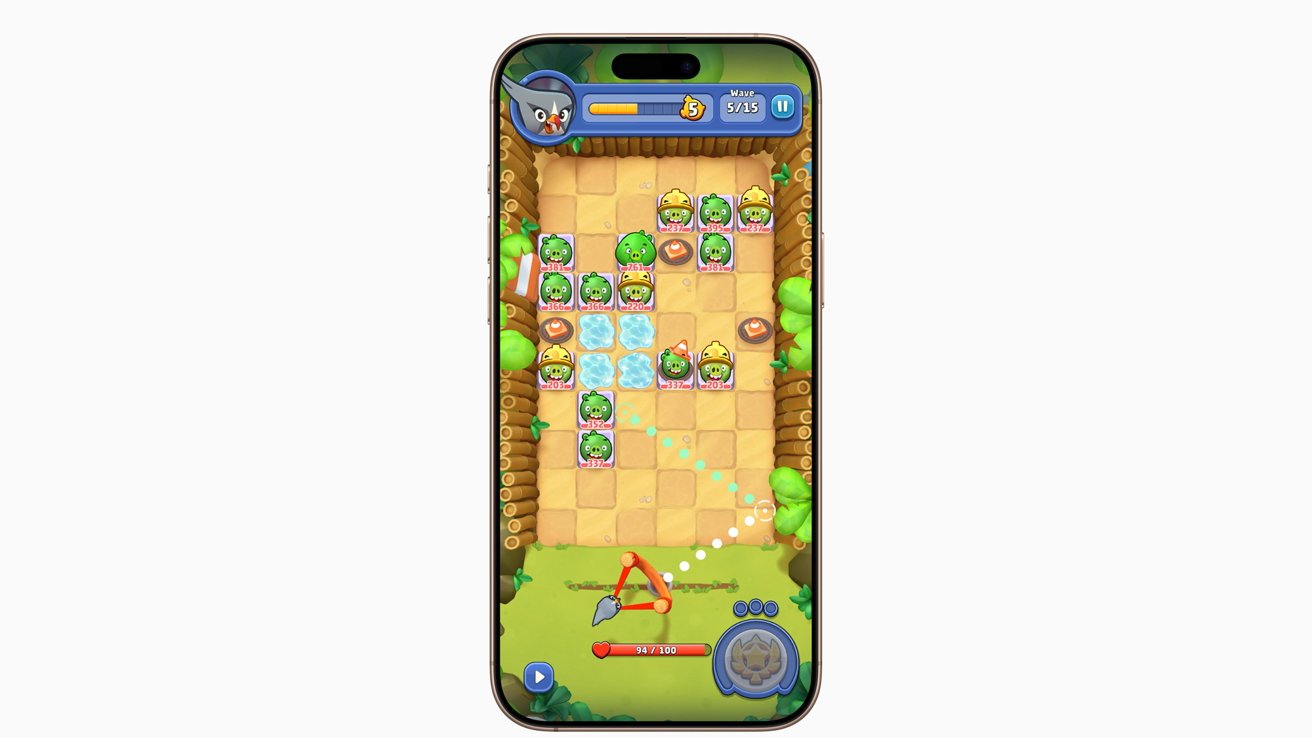 Smartphone displaying a colorful puzzle game with small green characters on a grid. A slingshot is at the bottom, arrow pointing to the grid, surrounded by trees and game indicators.