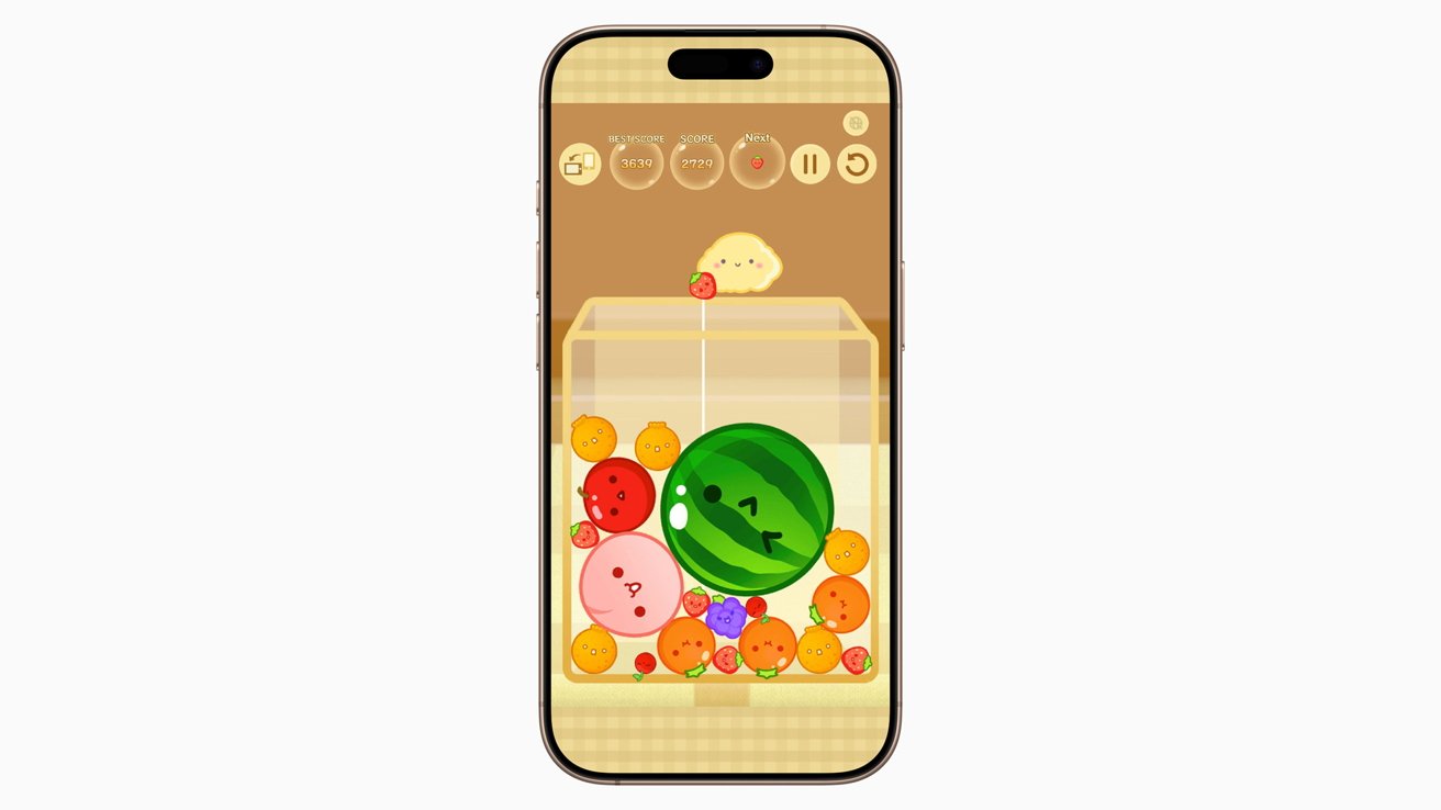 Smartphone displaying a game with stackable smiling fruit and candy pieces in a clear container against a brown background.